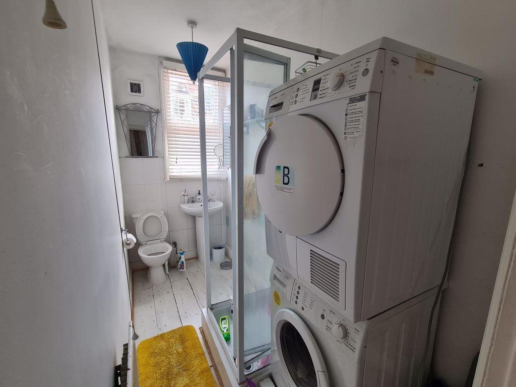 A clean and functional bathroom with a washing ...