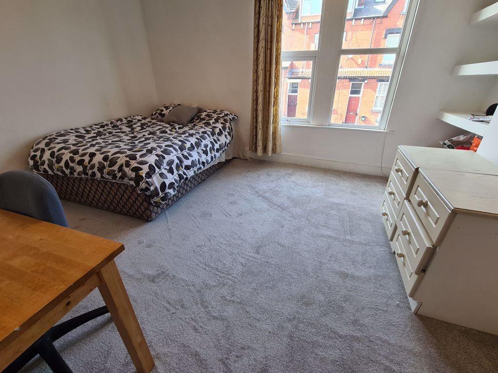A cozy and well-maintained bedroom featuring a ...