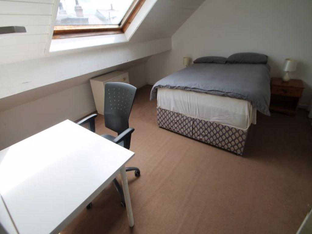 A bright and comfortable master bedroom with a ...