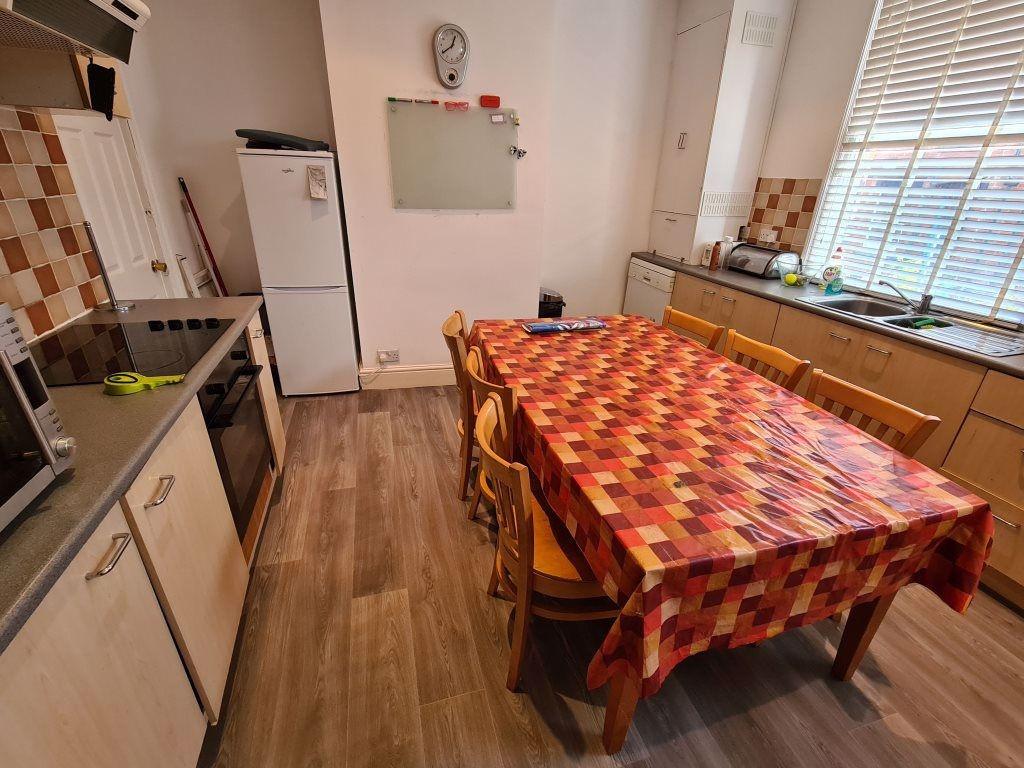 A bright and welcoming kitchen with ample natur...