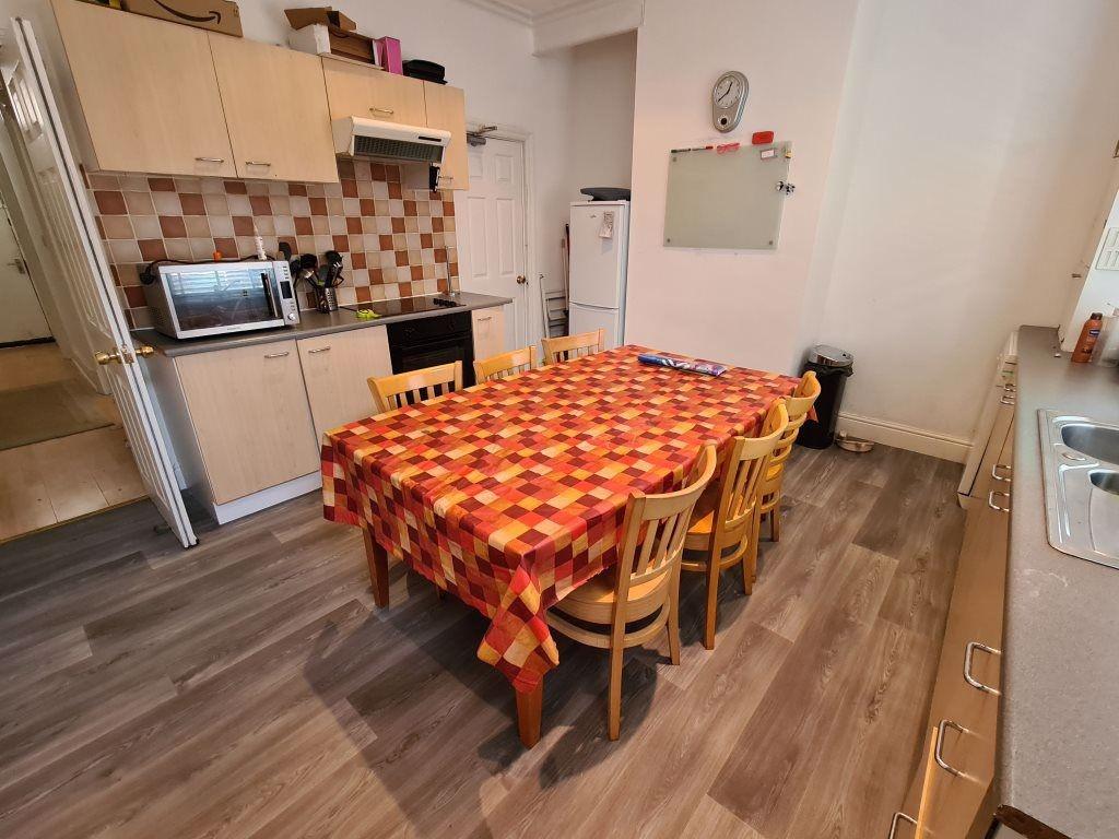 A well-maintained kitchen area featuring a chee...