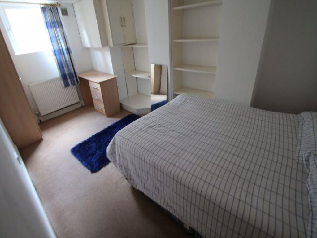 A tidy and well-maintained bedroom featuring a ...