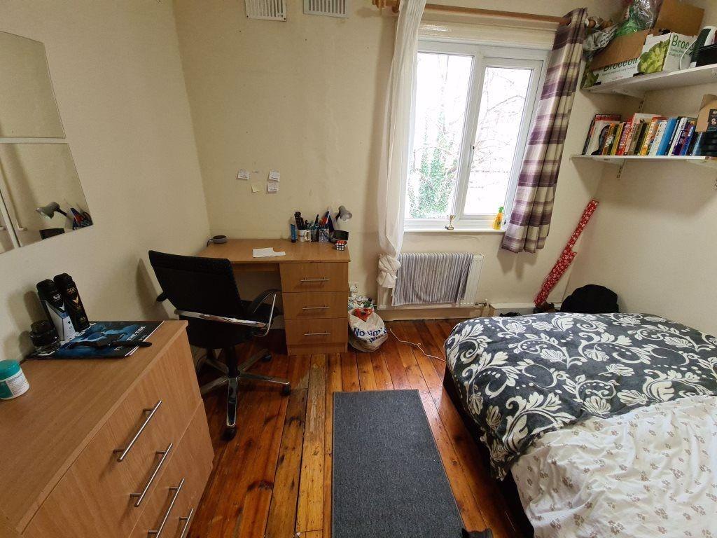 A well-lit spacious master bedroom featuring a ...