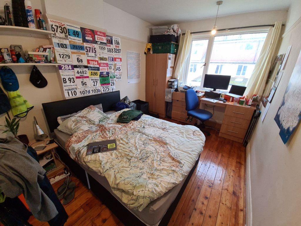 A welcoming and well-lit master bedroom featuri...