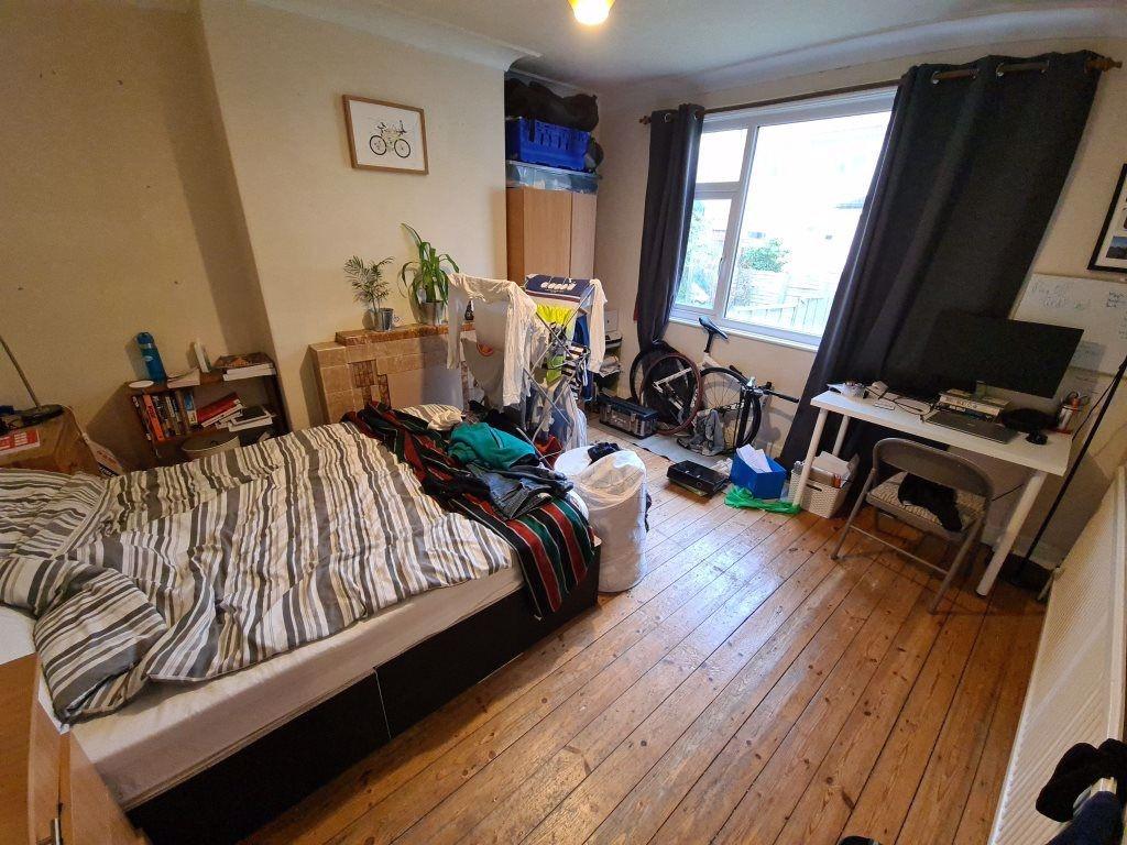 A cozy bedroom featuring a large bed, with natu...