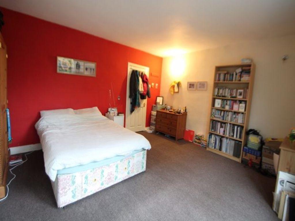 A spacious and welcoming double bedroom with a ...