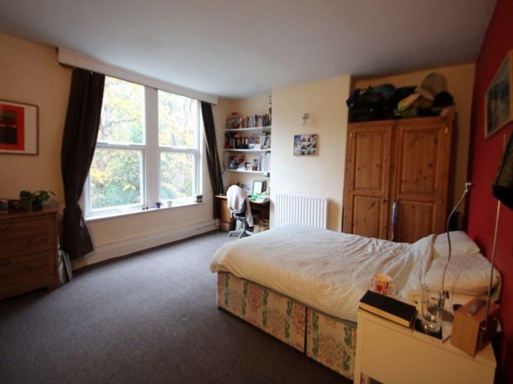 A cozy bedroom featuring a double bed, a large ...