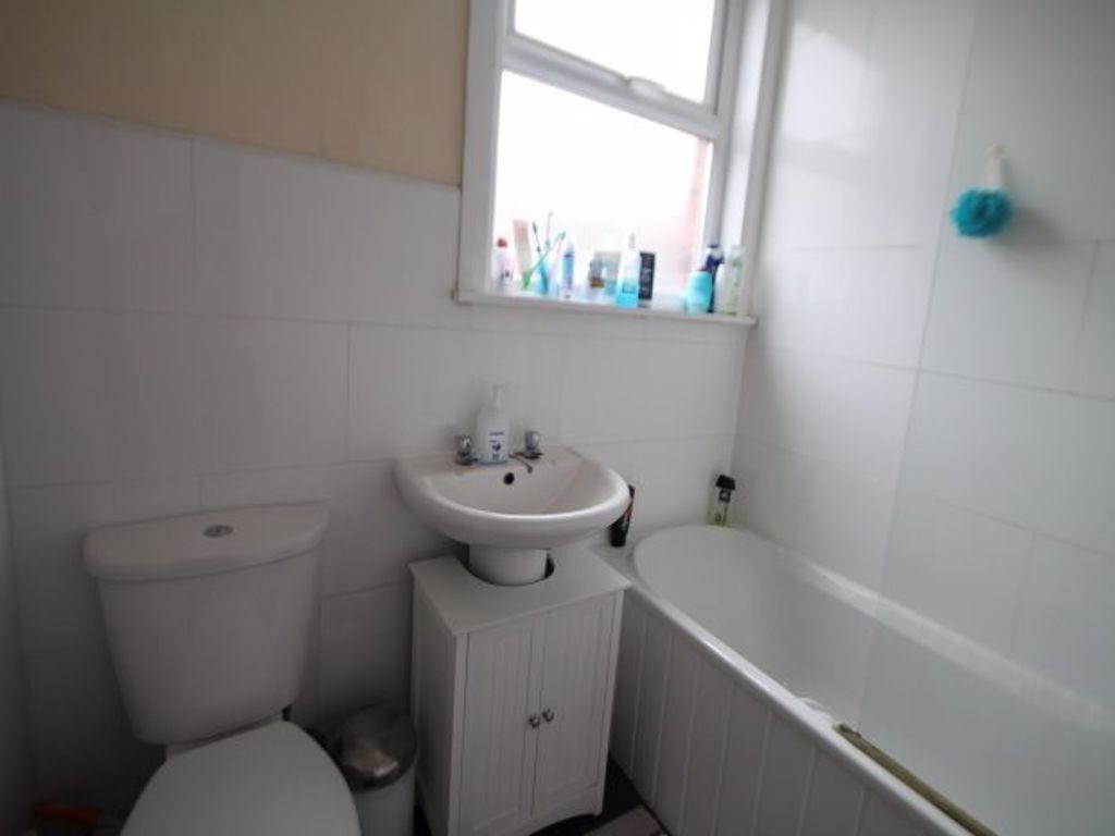 A clean, well-maintained bathroom with a bathtu...