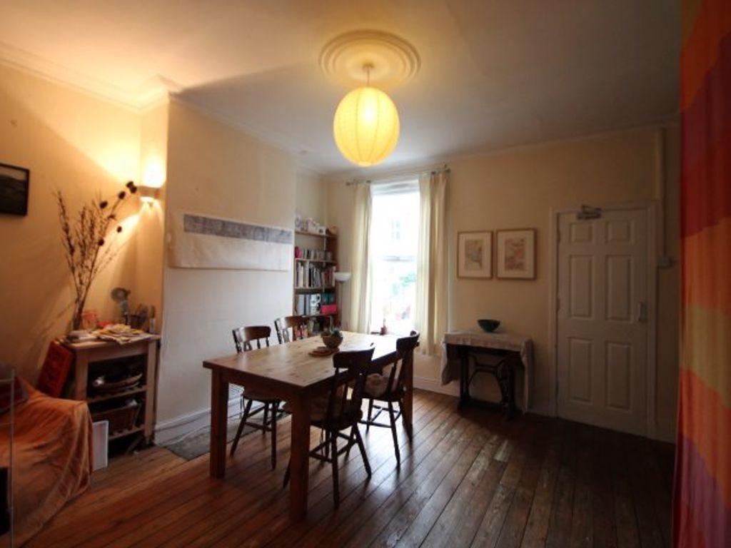 A well-lit, spacious living room with a cozy at...