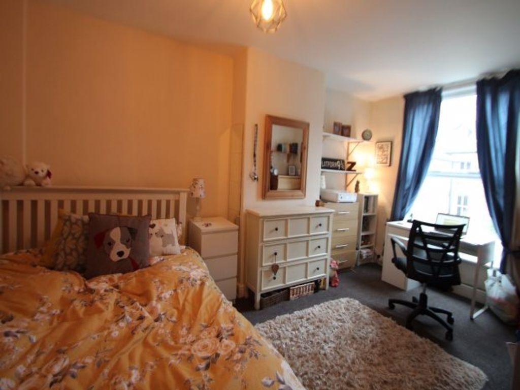 A cozy and well-maintained bedroom featuring a ...