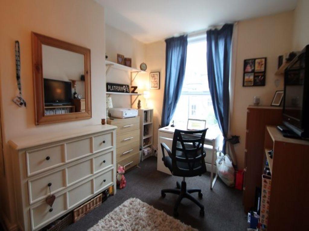 A bright, well-lit bedroom featuring a window w...