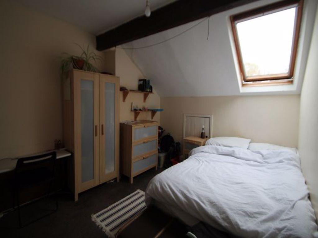 A cozy and well-maintained bedroom featuring a ...