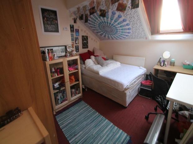A cozy and well-maintained bedroom featuring a ...