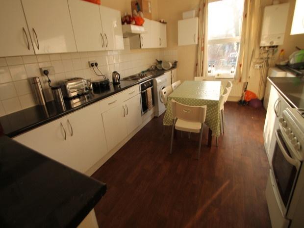 A well-lit kitchen with ample counter space, mo...