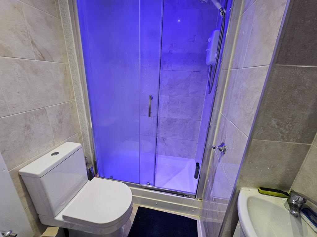 A modern bathroom featuring a shower cubicle il...