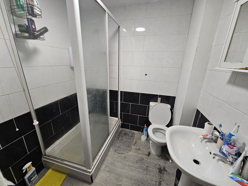 A clean and modern bathroom featuring a shower ...