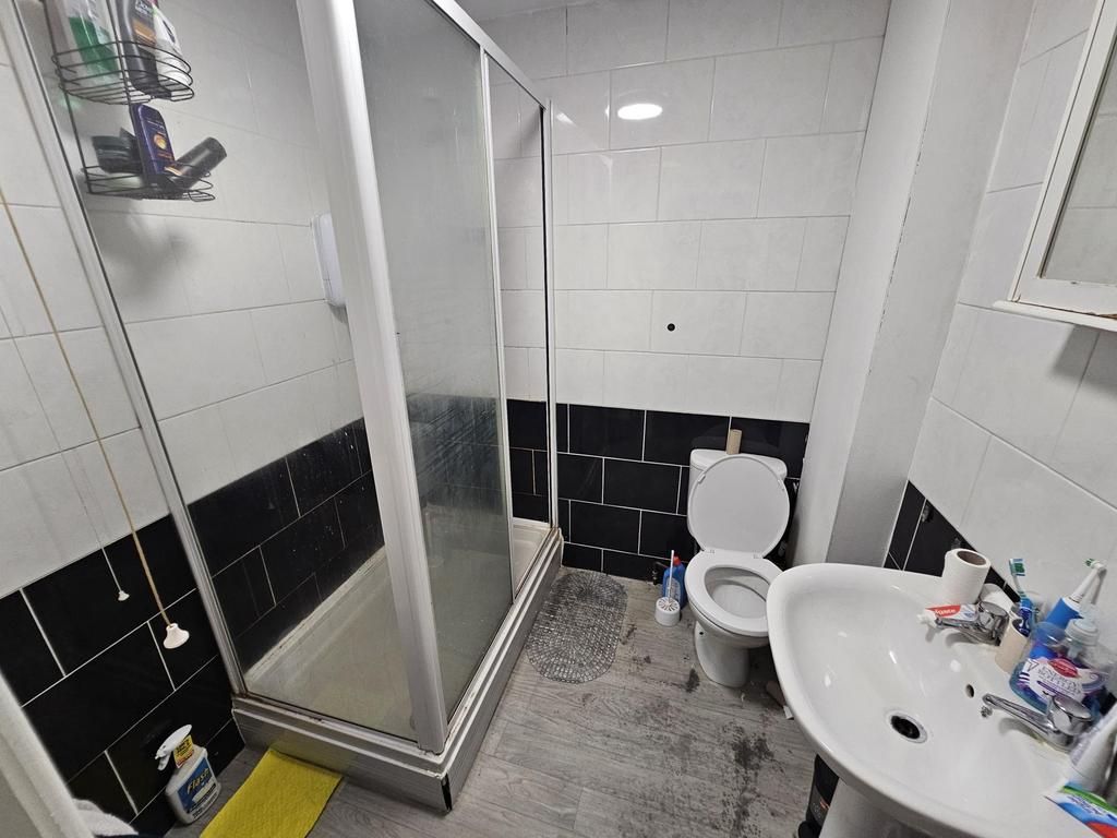 A well-maintained bathroom featuring a large sh...