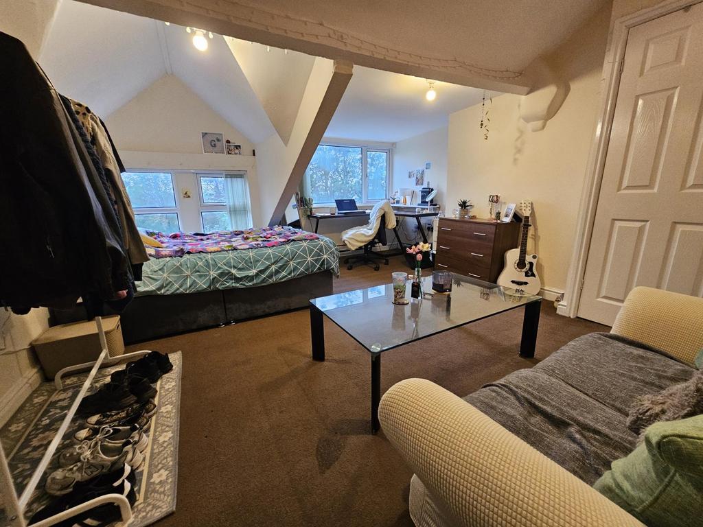 A spacious and cozy living room with large wind...