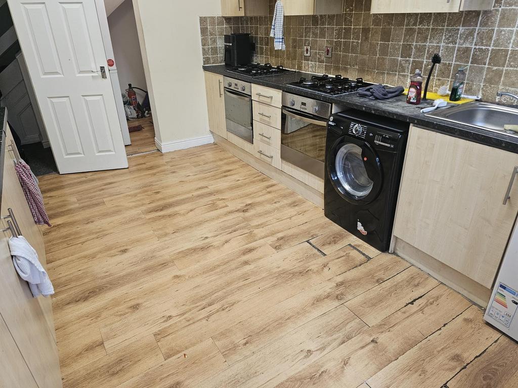 Modern kitchen with wooden flooring, equipped w...