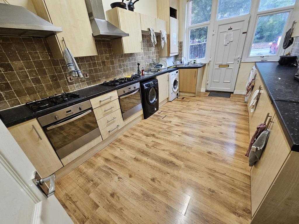Bright modern kitchen with wood-effect flooring...