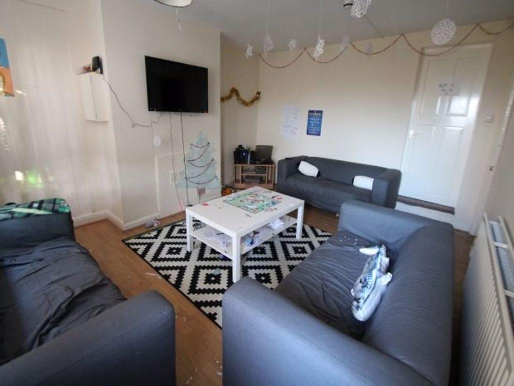 A spacious and well-lit living room featuring c...