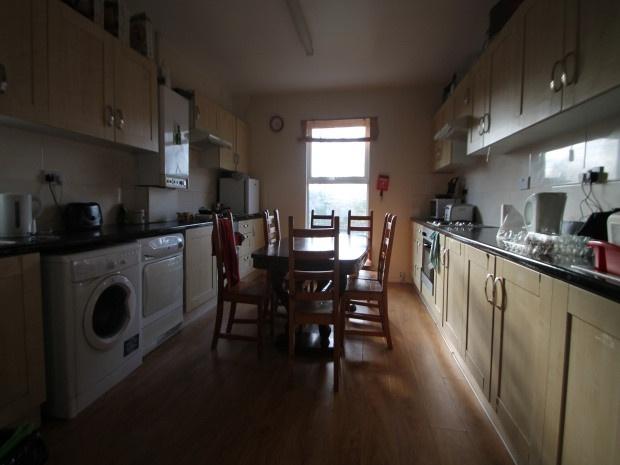 A well-lit and tidy kitchen with modern applian...