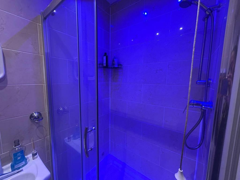 Modern bathroom with a spacious shower area, il...
