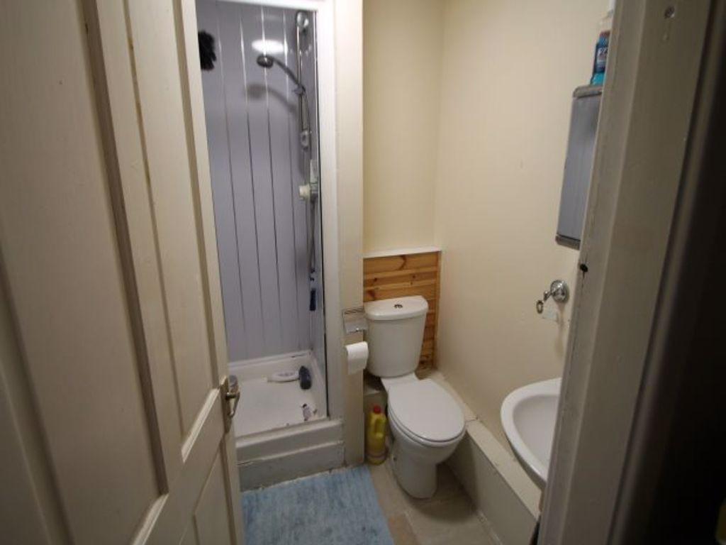 A clean and tidy bathroom featuring a shower un...
