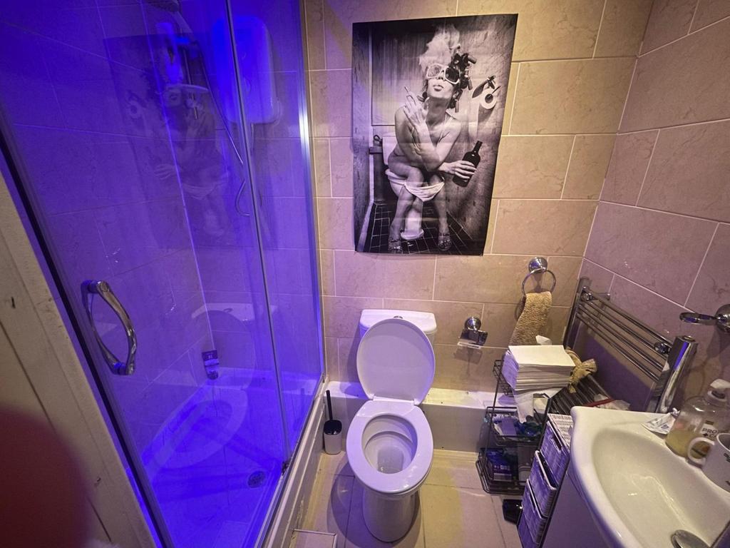 A clean, modern bathroom with a large shower, s...