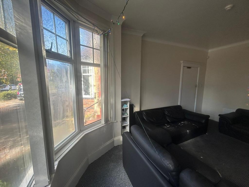 Bright and spacious living room with large wind...