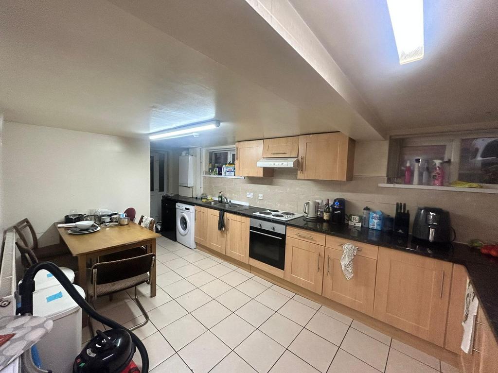 A well-maintained, well-lit kitchen with ample ...