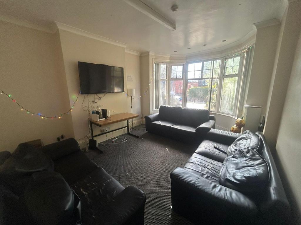 A spacious and well-lit living room featuring l...