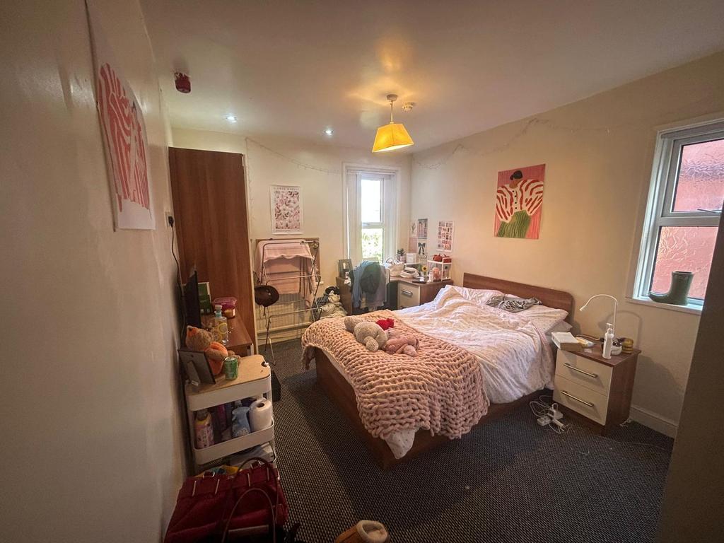 A cozy and well-maintained bedroom with natural...