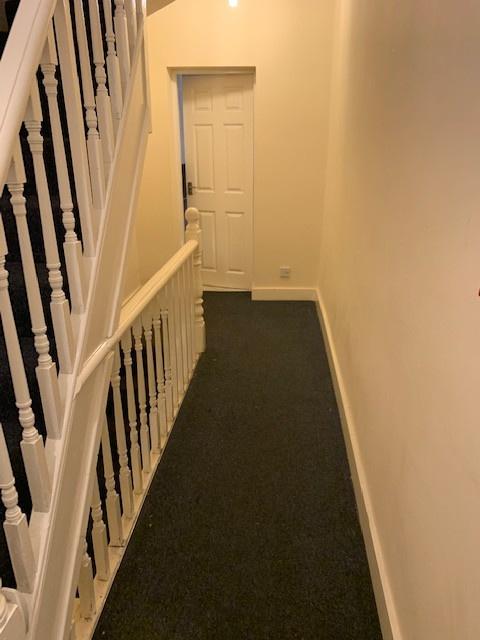 A well-maintained hallway with neutral walls, f...