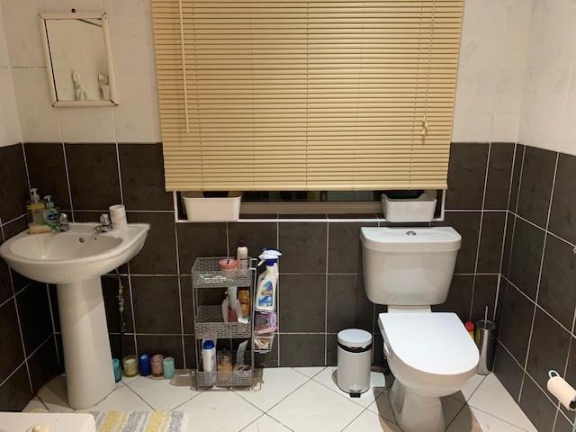 A well-maintained bathroom featuring a sink, to...