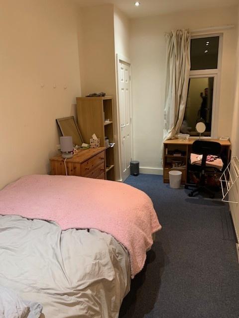 A cozy double bedroom featuring a neatly made b...