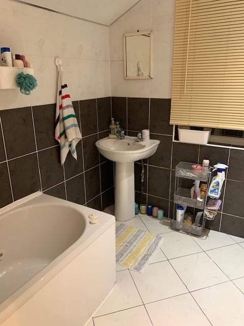 A functional bathroom featuring a bathtub, a si...