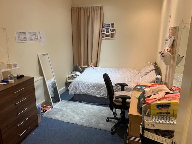 A comfortable bedroom featuring a double bed, a...