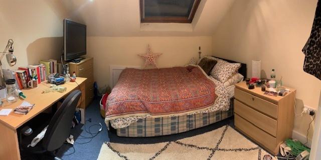 A spacious, well-lit master bedroom featuring a...