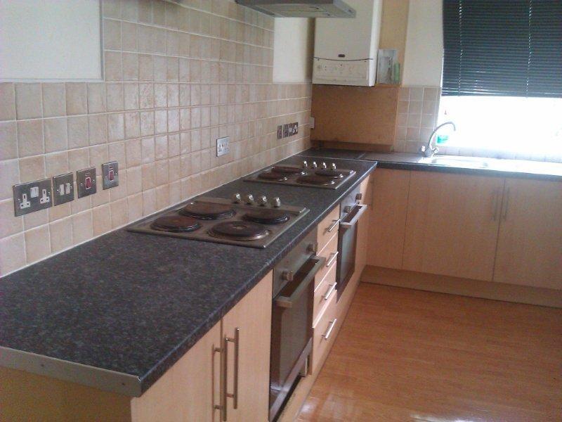 A well-maintained kitchen with a sleek black co...