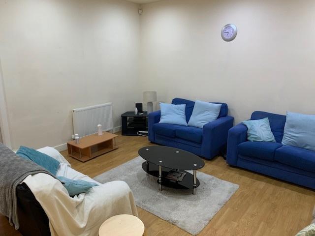 A contemporary living room featuring two blue s...