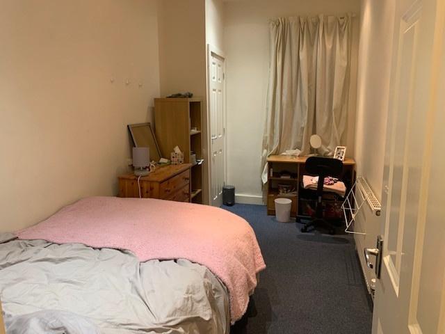 A cozy double bedroom with a comfortable bed, a...