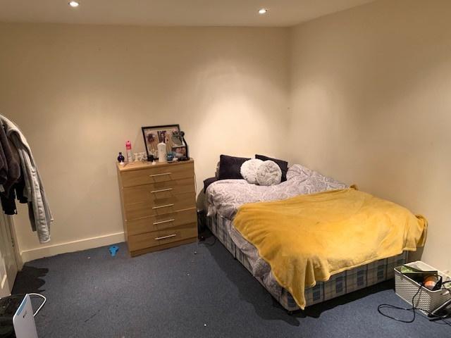 A spacious and inviting master bedroom featurin...