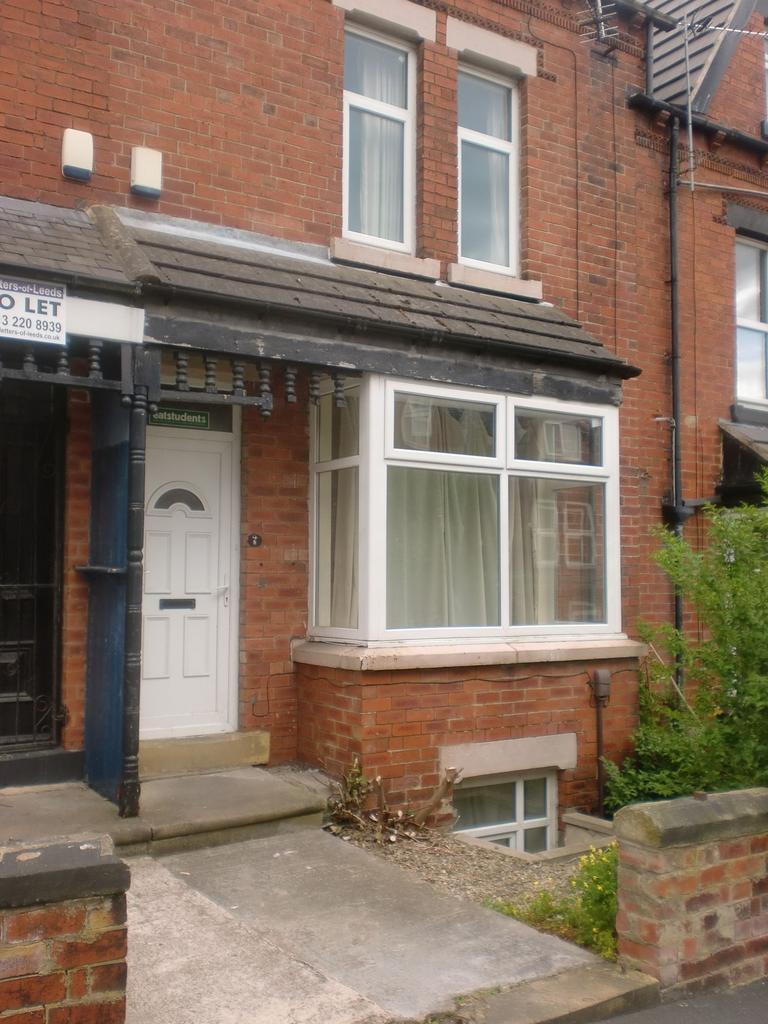 The exterior front of a traditional brick house...