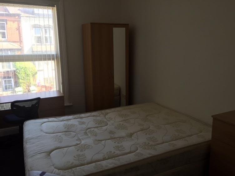 A straightforward bedroom with a bed and minima...