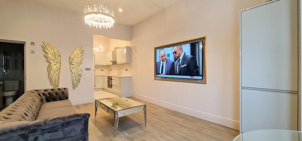 A bright and modern living room featuring a lar...