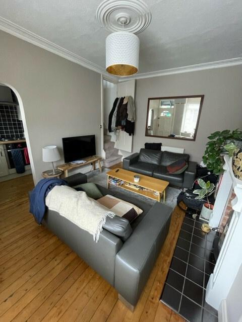 A bright and welcoming living room featuring co...