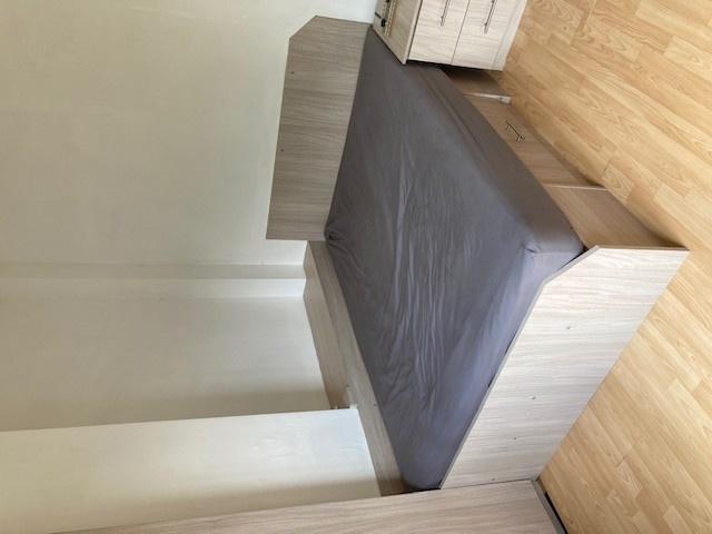 Neat, modern bedroom with a double bed set agai...