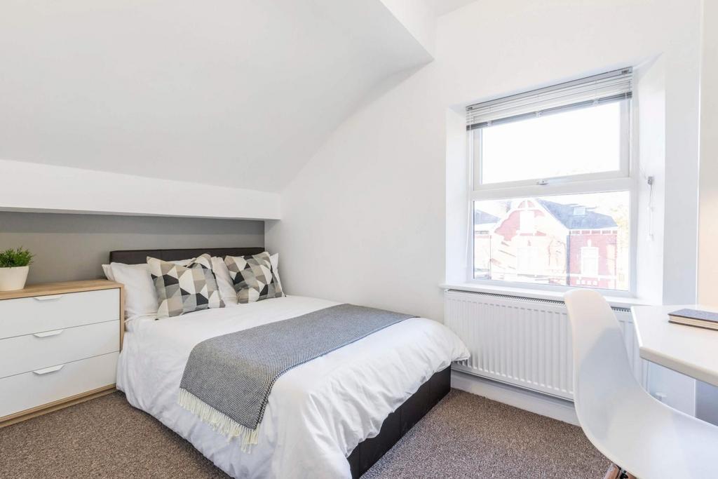 Bright and inviting master bedroom with a comfo...