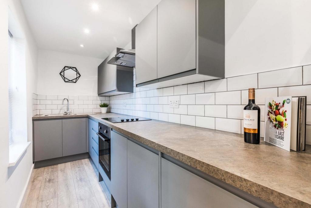 A modern, well-lit kitchen featuring a spacious...